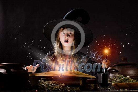 Little Halloween witch making magic with stick Little Halloween witch making magic with stick
