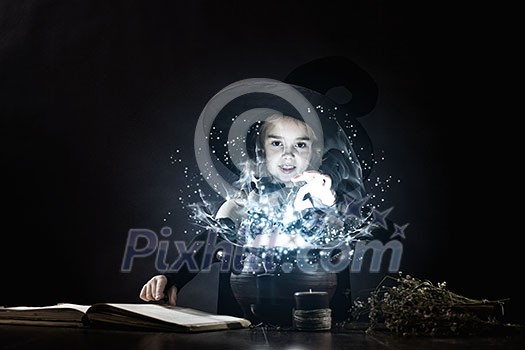 Little Halloween witch reading conjure above pot Little Halloween witch reading conjure above pot