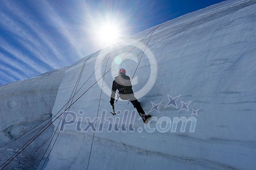 Low angle view of man climbing glacier Low angle view of man climbing glacier