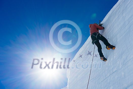 Low angle view of man climbing glacier Low angle view of man climbing glacier