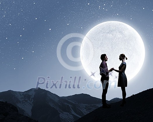 Silhouettes of couple against big moon at background Silhouettes of couple against big moon at background