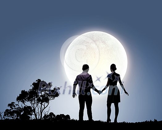 Silhouettes of couple against big moon at background Silhouettes of couple against big moon at background