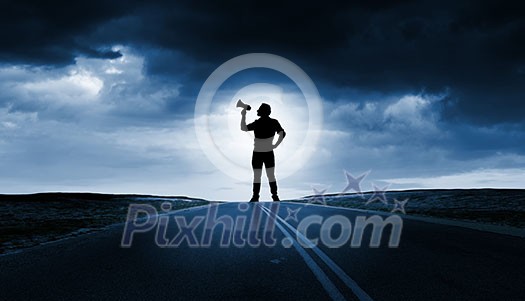 Silhouette of man screaming in trumpet at night Silhouette of man screaming in trumpet at night