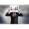 Businessman hiding face behind paper sheet. Strategy concept