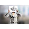 Businesswoman hiding her face behind paper sheet