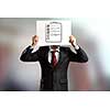 Businessman hiding his face behind paper sheet with sketches