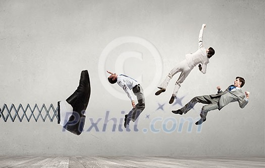 Big businessman foot on spring kicking business people