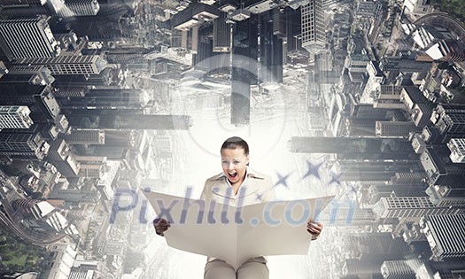 Portrait of young businesswoman in white suit reading blank newspaper Portrait of young businesswoman in white suit reading blank newspaper
