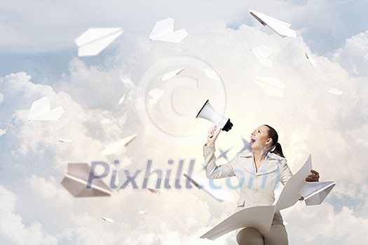 Portrait of young businesswoman with newspaper screaming in megaphone Portrait of young businesswoman with newspaper screaming in megaphone