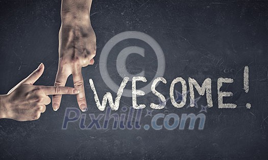 Awesome word written on wall and fingers instead letter A Awesome word written on wall and fingers instead letter A