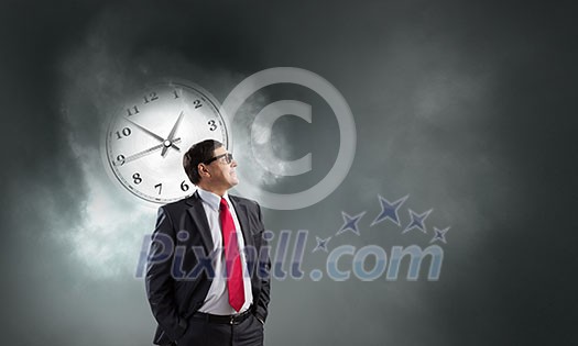 Middle-aged confident businessman in glasses and time concept Middle-aged confident businessman in glasses and time concept
