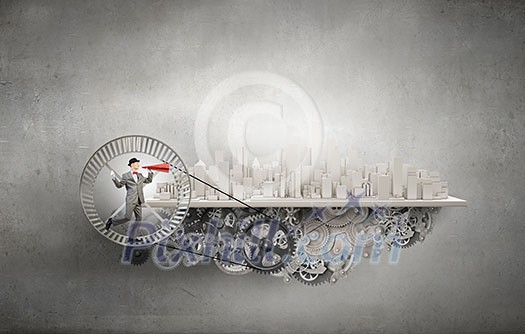 Young businessman running in wheel and screaming emotionally in paper trumpet Young businessman running in wheel and screaming emotionally in paper trumpet