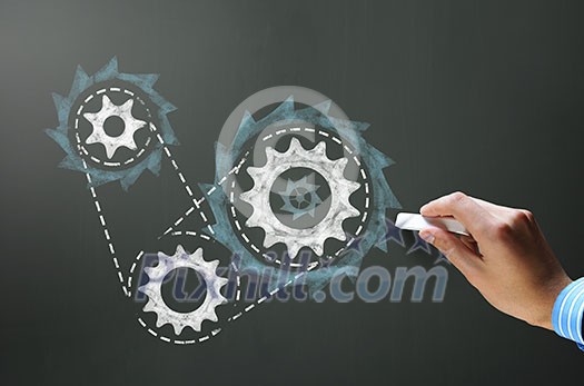 Businessman hand drawing with chalk gears mechanism as teamwork concept Businessman hand drawing with chalk gears mechanism as teamwork concept