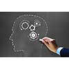 Businessman hand drawing with chalk gears mechanism as teamwork concept