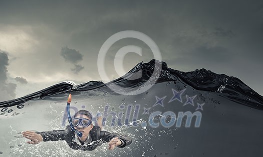 Young businesswoman in suit and diving mask swimming under water Young businesswoman in suit and diving mask swimming under water