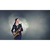 Young woman in suit with saxophone in hands