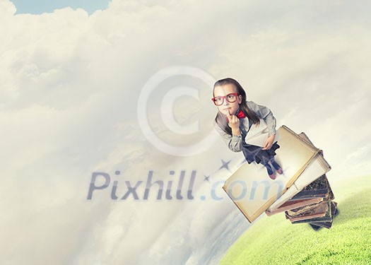 Wideangle picture of funny schoolgirl with paper plane in hand Wideangle picture of funny schoolgirl with paper plane in hand