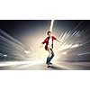 Handsome teenager cool acive boy riding skateboard