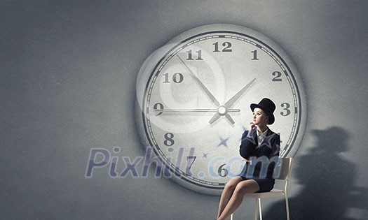 Pretty girl wearing retro hat siting on chair Pretty girl wearing retro hat siting on chair