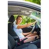 Young woman driving her car, on her way home from work - doing the daily commute