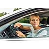 Young woman driving her car, on her way home from work - doing the daily commute