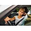 Young woman driving her car, on her way home from work - doing the daily commute