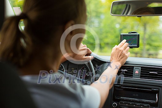 Young woman driving her car, on her way home from work - doing the daily commute