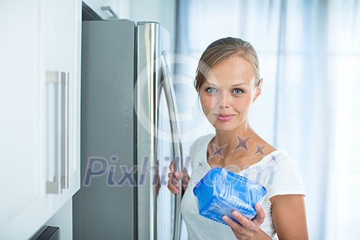Is this still fine? Pretty, young woman in her kitchen by the fridge, looking at the expiry date of a product she took from her fridge - Is this still fine? Pretty, young woman in her kitchen by the fridge, looking at the expiry date of a product she took from her fridge -