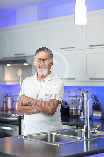 Senior man standing in his renovated, modern kitchen, Senior man standing in his renovated, modern kitchen,