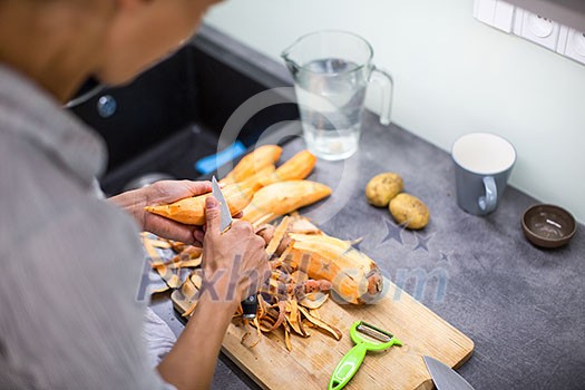 Young woman cooking in her modern kitchen (shallow DOF; color toned image) Young woman cooking in her modern kitchen (shallow DOF; color toned image)