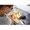 Young woman cooking in her modern kitchen (shallow DOF; color toned image)