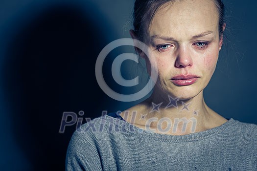 Young woman suffering from severe depression/anxiety/sadness, crying, tears coming from her eyes Young woman suffering from severe depression/anxiety/sadness, crying, tears coming from her eyes