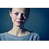 Young woman suffering from severe depression/anxiety/sadness, crying, tears coming from her eyes