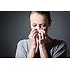 Young woman suffering from severe depression/anxiety/sadness, crying, tears coming from her eyes, blowing her nose