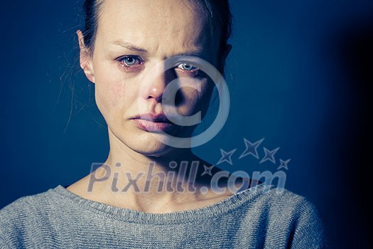 Young woman suffering from severe depression/anxiety/sadness, crying, tears coming from her eyes Young woman suffering from severe depression/anxiety/sadness, crying, tears coming from her eyes