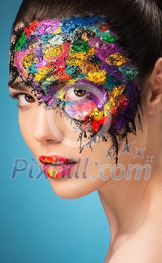Beautiful fashion woman color face art on blue background Beautiful fashion woman color face art on blue background