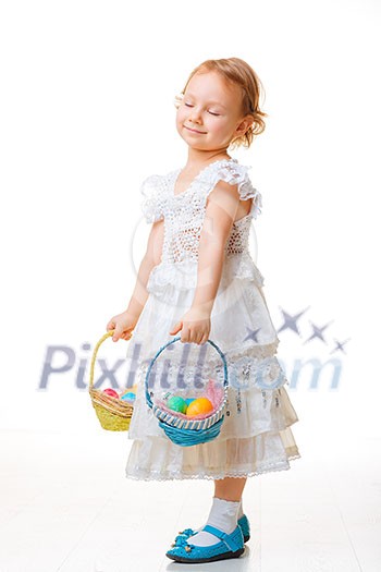 Little girl with baskets filled with Easter eggs Little girl with baskets filled with Easter eggs
