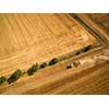 Aerial view of a tractor working a field after harvest