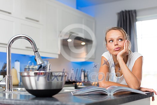 Pretty, young woman in her modern, clean and bright kitchen, uncertain about what to cook (color toned imagey; shallow DOF) Pretty, young woman in her modern, clean and bright kitchen, uncertain about what to cook (color toned imagey; shallow DOF)