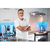Senior man standing in his renovated, modern kitchen,