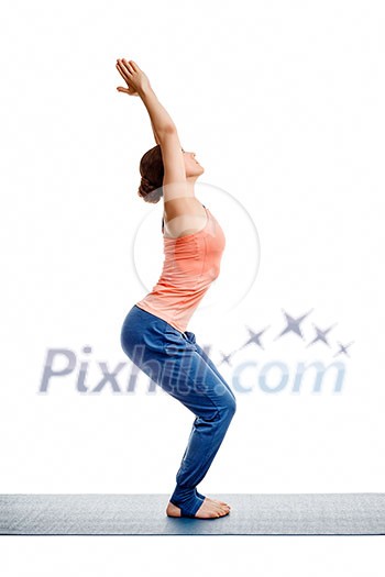 Sporty fit woman doing Surya Namaskar ashtanga vinyasa yoga asana Utkatasana - chair pose isolated on white Sporty fit woman doing Surya Namaskar ashtanga vinyasa yoga asana Utkatasana - chair pose isolated on white