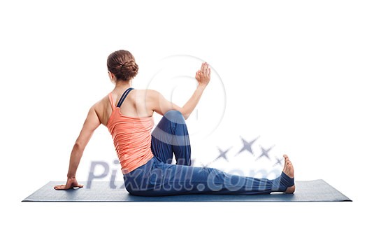 Beautiful sporty fit yogini woman practices yoga asana Marichyasana C - seated spinal twist isolated on white Beautiful sporty fit yogini woman practices yoga asana Marichyasana C - seated spinal twist isolated on white