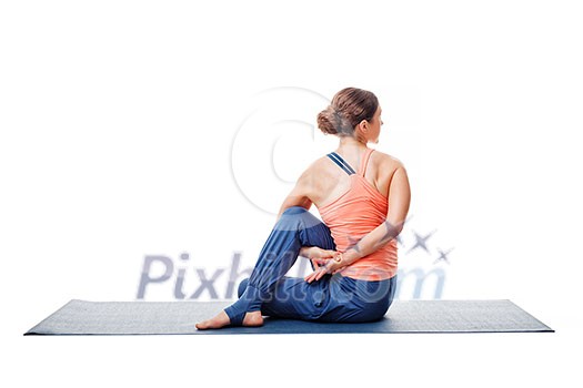 Beautiful sporty fit woman practices yoga asana Ardha matsyendrasana - half spinal twist pose isolated on white Beautiful sporty fit woman practices yoga asana Ardha matsyendrasana - half spinal twist pose isolated on white
