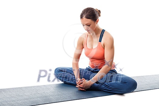 Beautiful sporty fit woman practices yoga asana Baddha konasana - bound angle pose isolated on white Beautiful sporty fit woman practices yoga asana Baddha konasana - bound angle pose isolated on white