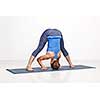 Beautiful sporty fit woman practices Ashtanga Vinyasa yoga asana Prasarita padottanasana B - wide legged forward bend B