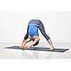 Beautiful sporty fit woman practices Ashtanga Vinyasa yoga asana Prasarita padottanasana C - wide legged forward bend C