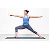 Beautiful sporty fit yogini woman practices yoga asana Virabhadrasana 2 - warrior pose 2