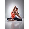 Beautiful sporty fit yogini woman practices yoga asana Eka pada rajakapotasana - one-legged pigeon pose in studio