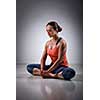 Beautiful sporty fit woman practices yoga asana Baddha konasana - bound angle pose