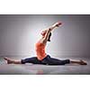 Sporty fit woman doing Hatha yoga asana Hanumanasana  (splits) - monkey pose